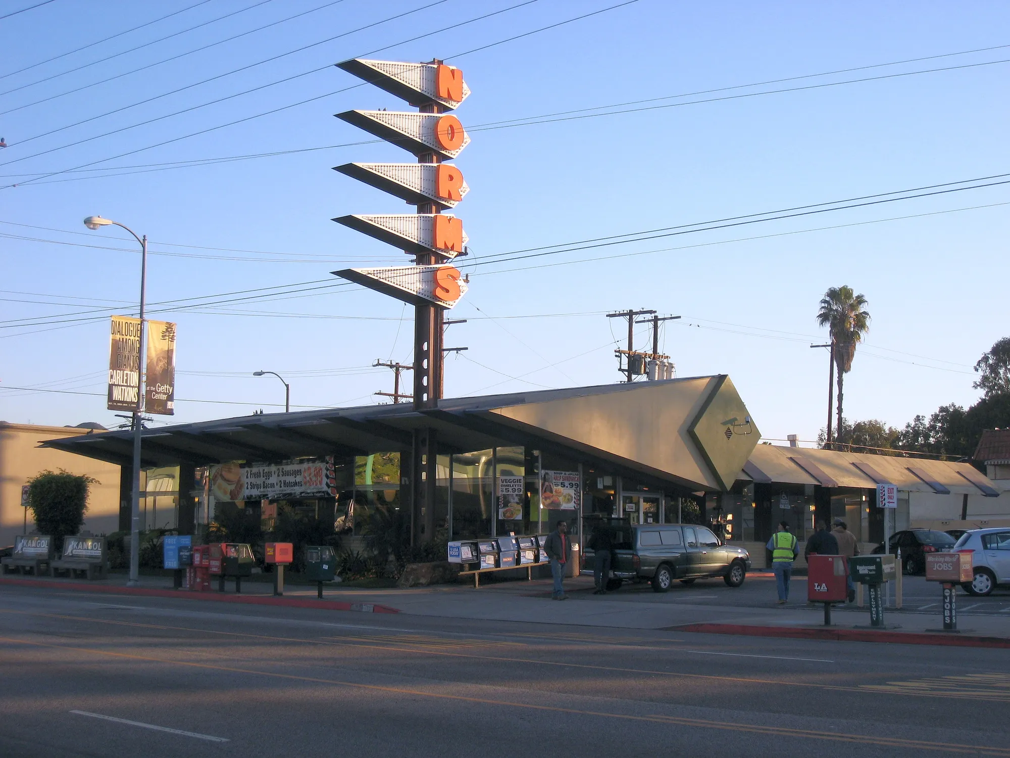 The tall NORMS sign and angled roofline of Norms restaurant on La Cienega Boulevard in Los Angeles.
