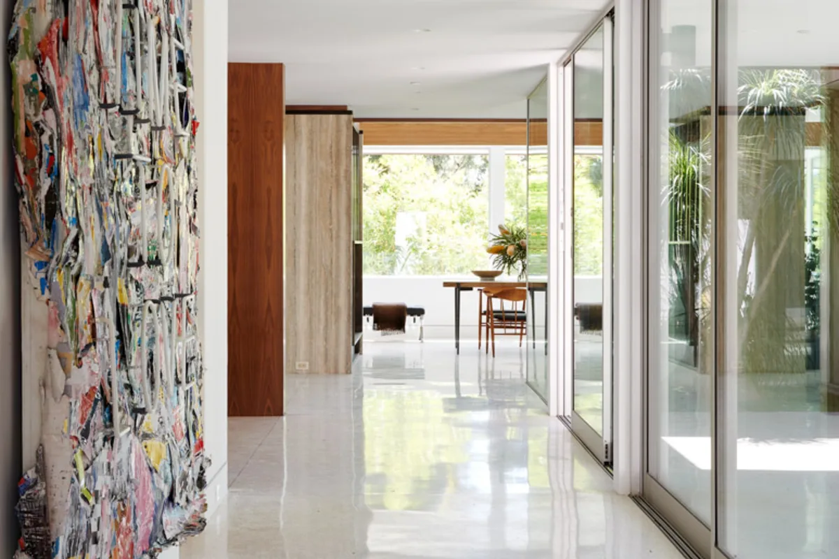 A terrazzo hallway at 1061 Loma Vista, Beverly Hills, opening to the garden.