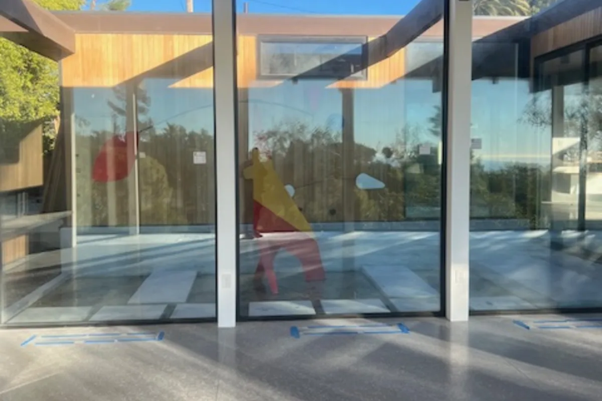 A glazed corner at 5637 Busch Drive, Malibu, under a timber soffit.